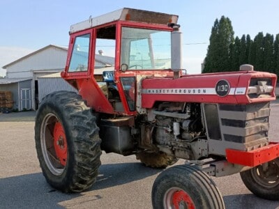 Massey Ferguson 1130 tractor with enclosed cab and large rear tires.