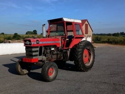 Red Massey Ferguson 1130 tractor with cab and front grille, parked outdoors.