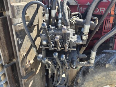 Close-up of hydraulic controls and hoses on a McCormick C70 tractor.