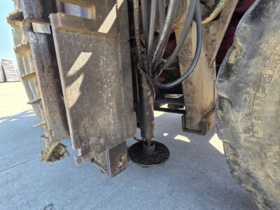 Close-up of hydraulic hoses and components on construction machinery.