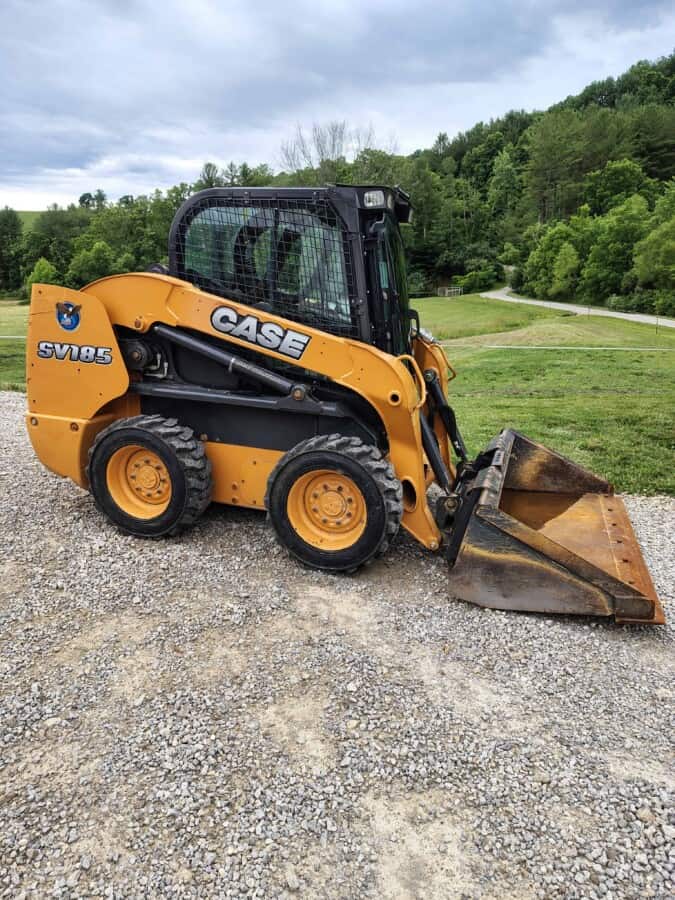 CASE SV185 skid steer loader with bucket attachment on gravel surface.