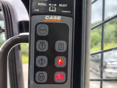 CASE construction equipment control panel with stop, warning, and parking brake indicators.