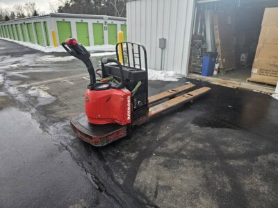 2006 Raymond 8400 electric pallet jack with extended forks and operational controls.