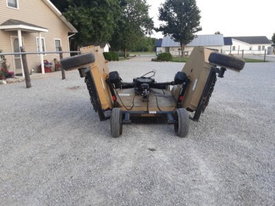 John Deere utility cart with foldable sides and pneumatic tires for farm or landscaping use.