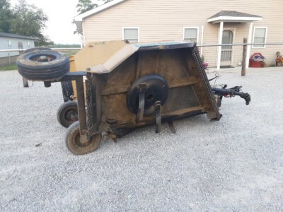 Used lawn sweeper with large collection bag and wheels, suitable for yard cleanup.
