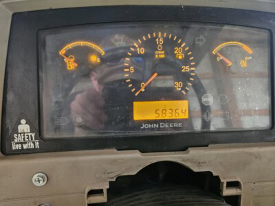 John Deere 6100D tractor dashboard with fuel, RPM, and temperature gauges.