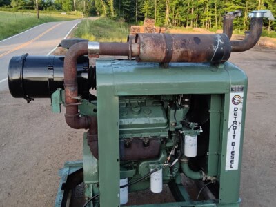 Green industrial power unit with exhaust pipe and filters, used for heavy machinery.