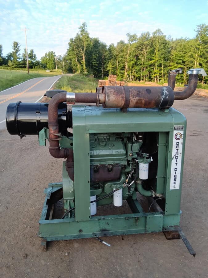 Green industrial power unit with exhaust pipe and filters, used for heavy machinery.