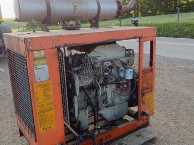 Orange portable generator with exhaust stack and engine components visible.