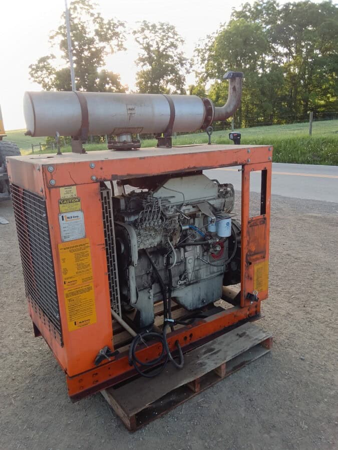 Orange portable generator with exhaust stack and engine components visible.