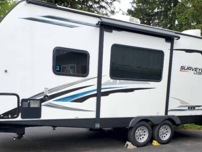2021 Forest River Surveyor 203RLKE travel trailer with slide-out and dual axles.