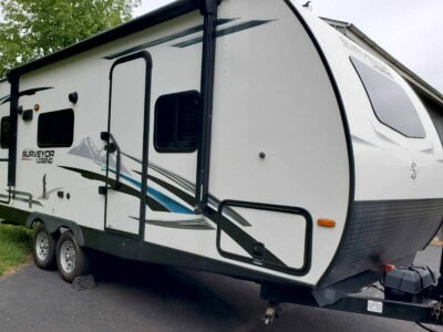 2021 Forest River Surveyor 203RLKE travel trailer with aerodynamic front and side windows.