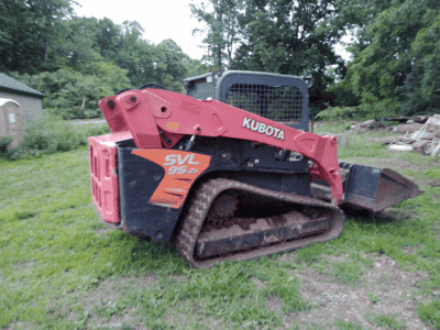 2018 Kubota SVL95-2 compact track loader with bucket attachment on grassy field.