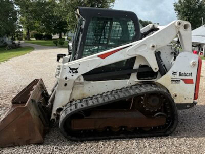 2018 Bobcat T650 skid steer loader with bucket attachment on gravel surface.