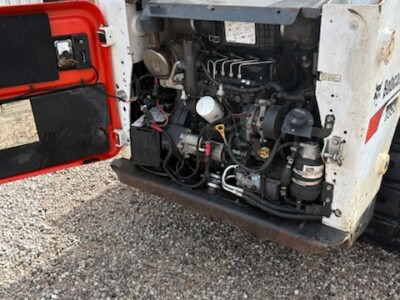 2018 BOBCAT T650 compact track loader engine with visible components and hydraulic connections.