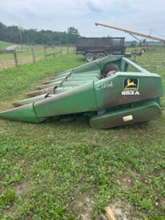 John Deere 653 6-Row All-Crop Head with green finish and visible cutting mechanism.