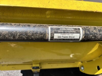 John Deere 54-inch tractor shovel with black metal arm and yellow body.