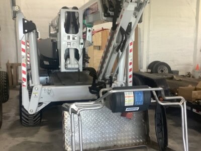 2022 DINO 92RXTE boom lift with extended arm and platform in warehouse.