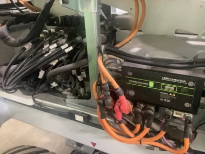Close-up of lithium battery control unit and wiring in industrial equipment.