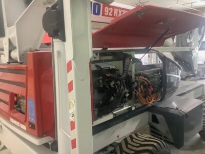 2022 DINO 92RXTE boom lift with open engine compartment and extended boom.