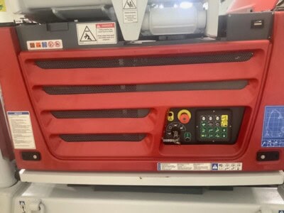 Close-up of DINO 92RXTE boom lift control panel with buttons and switches.