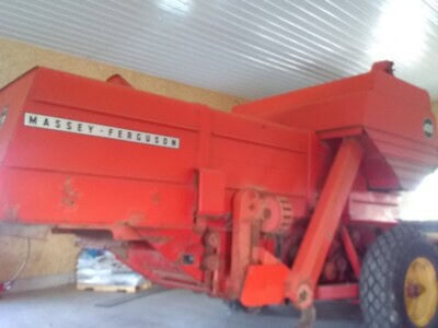 Red Massey Ferguson 405 grain cart with large wheels and unloading auger.