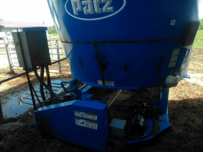 Blue PATZ 420 stationary TMR mixer with visible hydraulic system and feed chute.