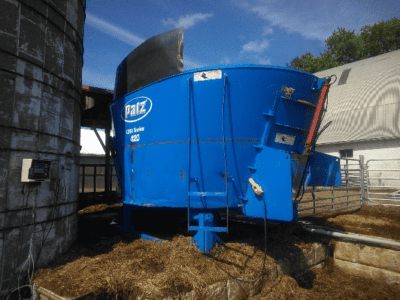 Blue PATZ 420 stationary TMR mixer with cab and mixing chamber, used in livestock feed operations.