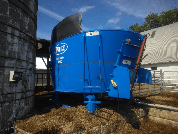 Blue PATZ 420 stationary TMR mixer with cab and mixing chamber, used in livestock feed operations.