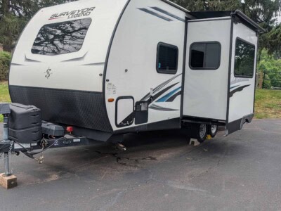 2021 Forest River Surveyor 203RLKE travel trailer with slide-out and modern exterior design.