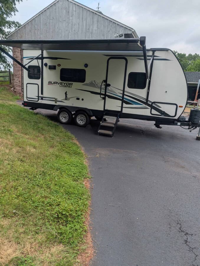 2021 Forest River Surveyor 203RLKE travel trailer with slide-out and awning.