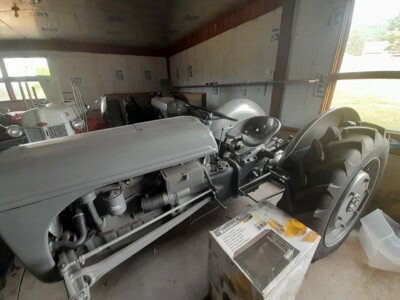 1939 Ford 9N tractor with gray paint, large rear tires, and vintage design in indoor setting.