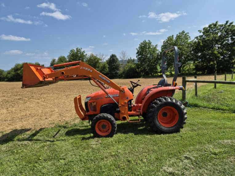 Resized_20260720_152616 Orange Kubota L3800D compact tractor with front loader attachment on grassy field.