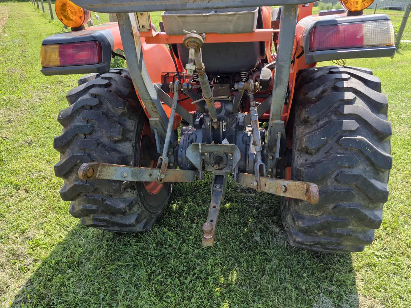 KUBOTA L3800D Tractor Rear View Rear view of a Kubota L3800D compact tractor with large tires and hitch system.