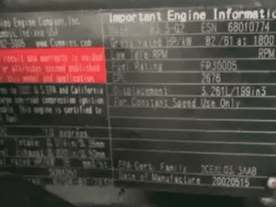 Engine information plate on Cummins Onan 50 kW generator with model and serial details.