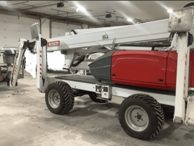 2022 DINO 92RXTE boom lift with extended arm and cab, in a warehouse setting.