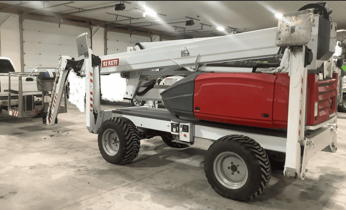 2022 DINO 92RXTE boom lift with extended arm and cab, in a warehouse setting.