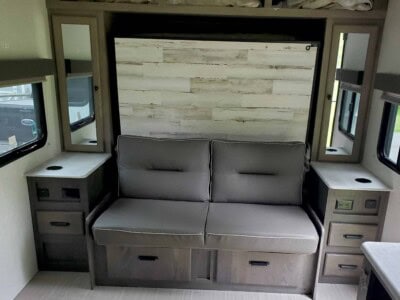 Interior view of 2021 Forest River Surveyor 203RLKE with sofa and storage.