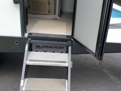 Entry step with three carpeted steps for Forest River Surveyor 203RLKE travel trailer.