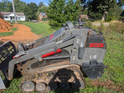 2023 Lynx LX-1200 compact track loader with enclosed cab and rubber tracks.