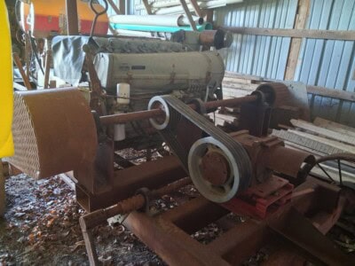 Deutz F6L912 diesel engine with visible belts and pulleys in a storage shed.