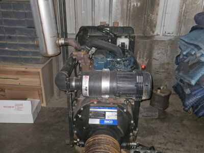 Kubota V3600 diesel power unit with exhaust and cooling system in a workshop.