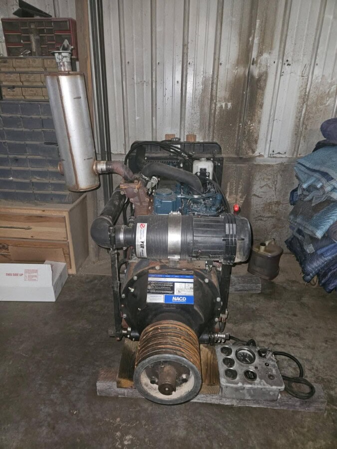 Kubota V3600 diesel power unit with exhaust and cooling system in a workshop.