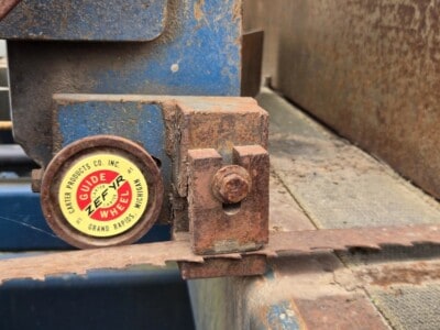 Close-up of rusted metal coupling on industrial equipment with ZEPYR wheel label.