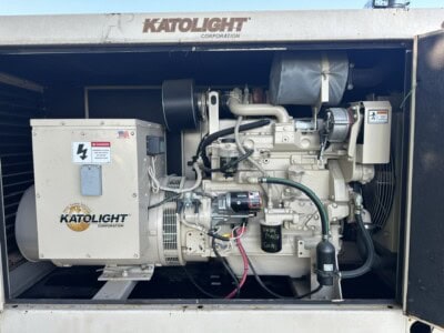 60 kW John Deere Katolight generator with industrial engine and control panel inside metal enclosure.