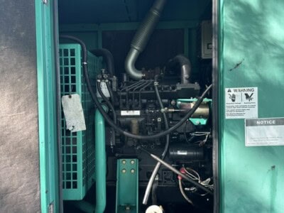 CUMMINS ONAN 50 kW generator engine with visible components and exhaust system.