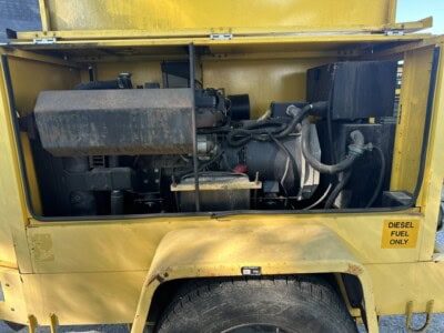 Yellow generator with diesel fuel label and visible engine components.