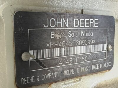 John Deere engine serial number plate with barcode and model info.