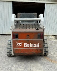 2020 Bobcat mini track loader with cab and tracks, used condition, front view.