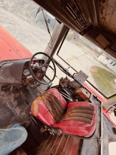2 Massey Ferguson 2745 tractor interior with red seat and dashboard controls.